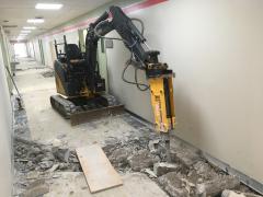 Concrete breaking inside building and dig down to sewer lines to add washroom in each room. 